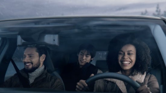 Three passengers riding in a vehicle and smiling | Nissan of San Jose in San Jose CA