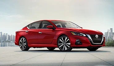 2023 Nissan Altima in red with city in background illustrating last year's 2022 model in Nissan of San Jose in San Jose CA